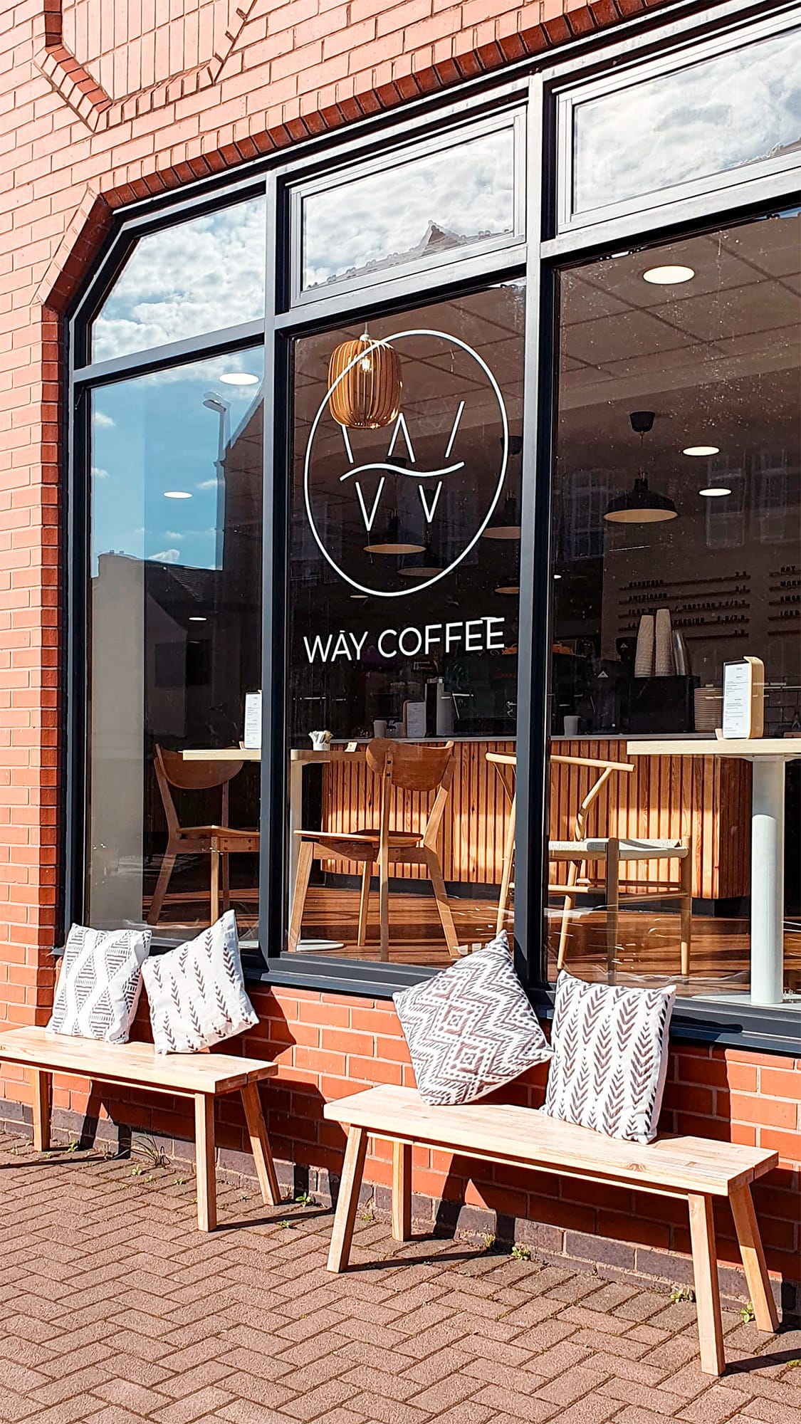 Photo taken outside Way Coffee showing the logo as a decal on the window.